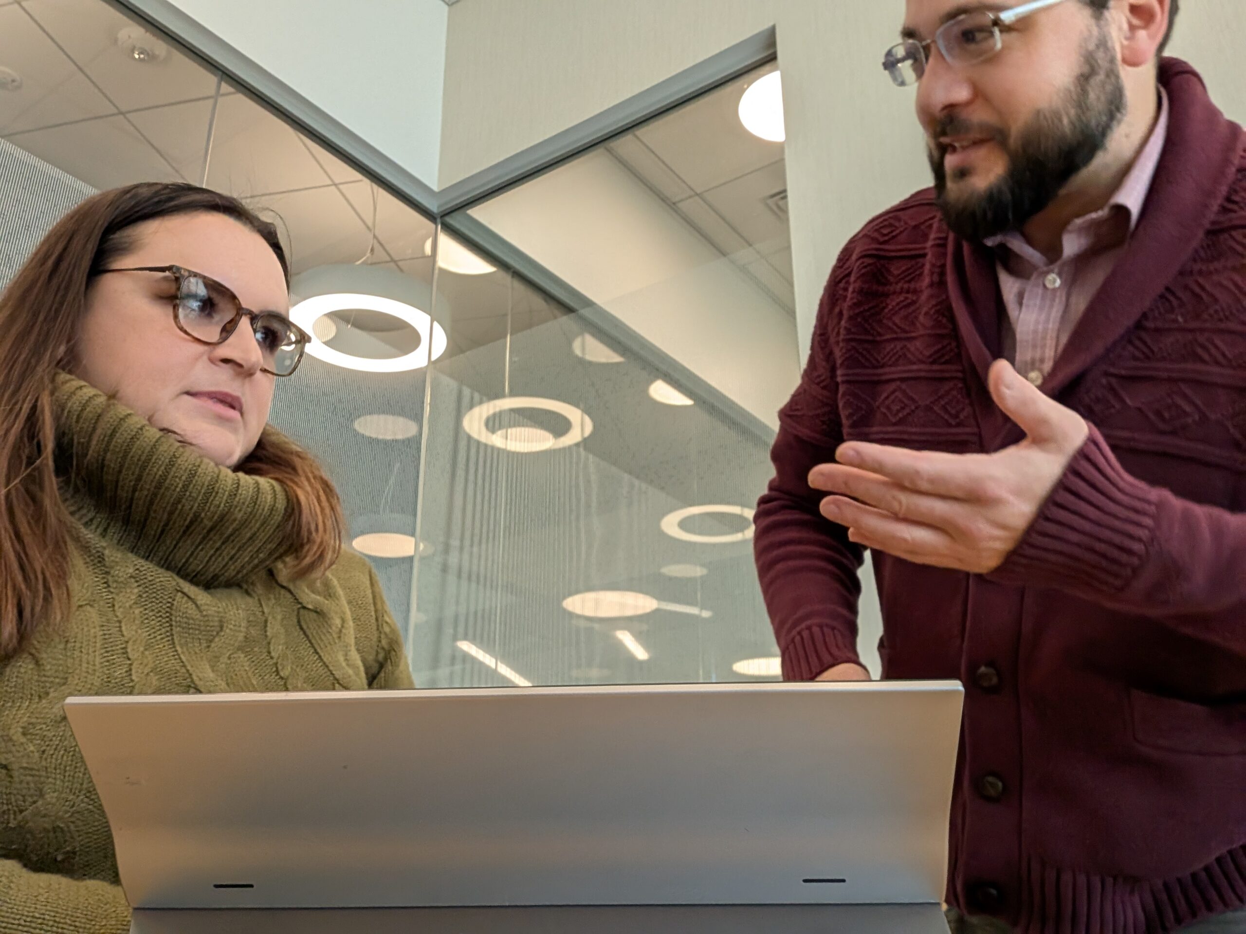 Dan Garmat and Caroline Stauss of AlignIQ working together at a laptop